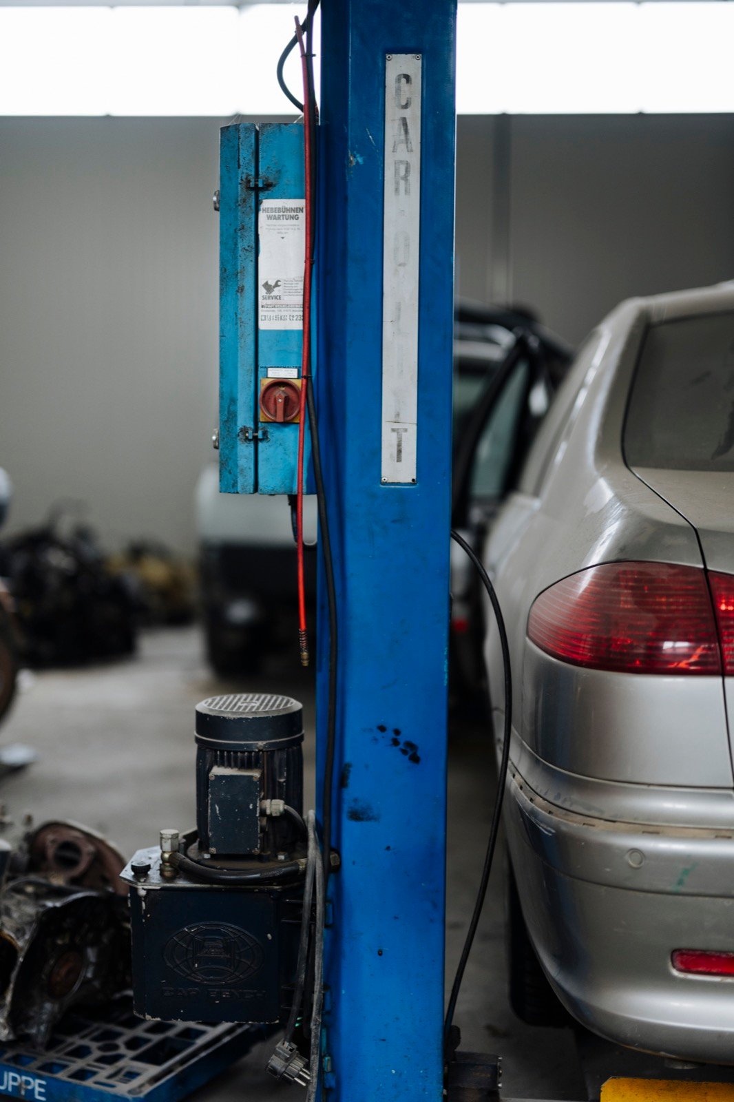Automobile service lift bay used to represent Shiva Automobiles workshop work